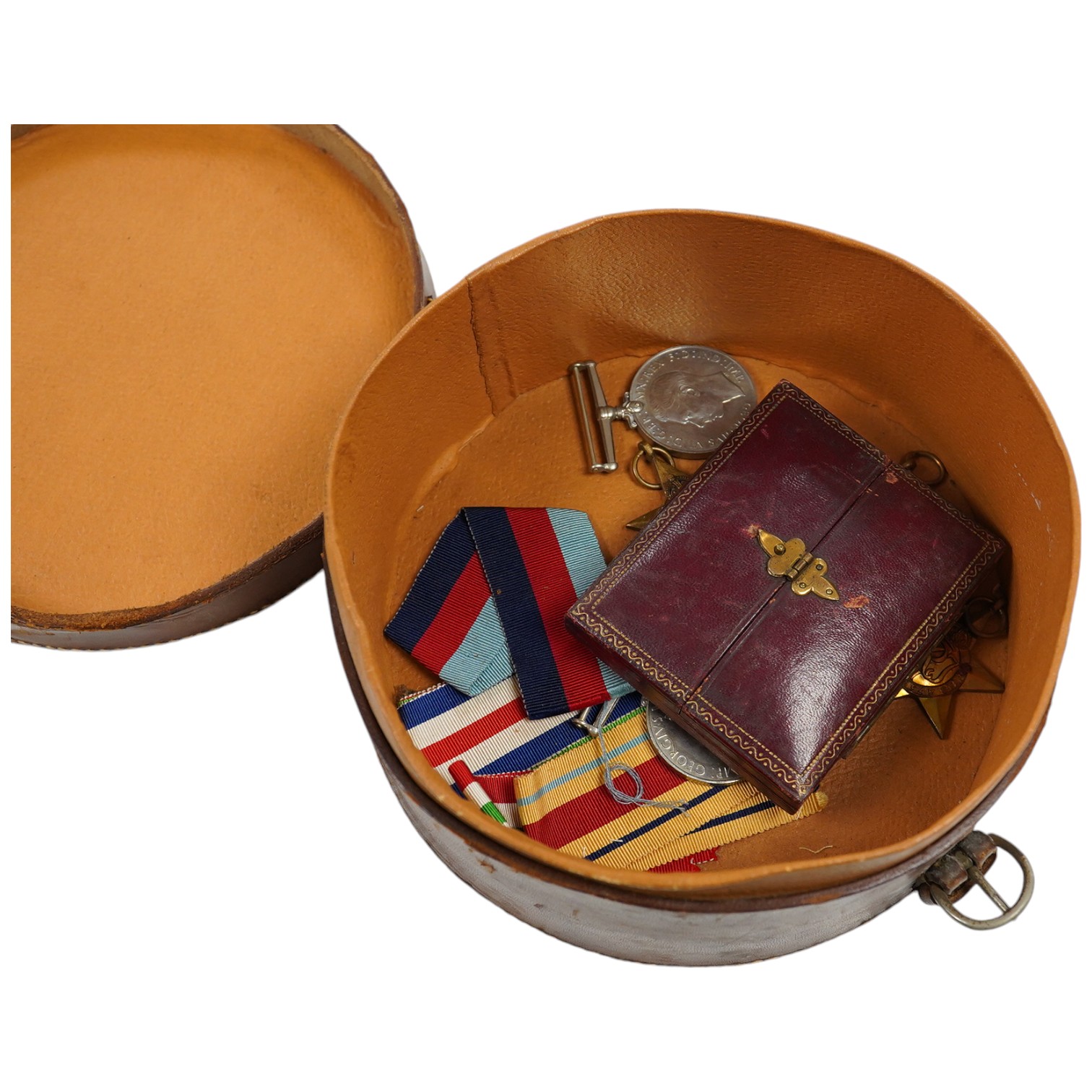 Five WWII medals including the Italy star, the France and Germany star, etc. and a cased miniature of a First World War officer in uniform, plus a leather cylindrical case. Condition - fair to good, significant chip to t